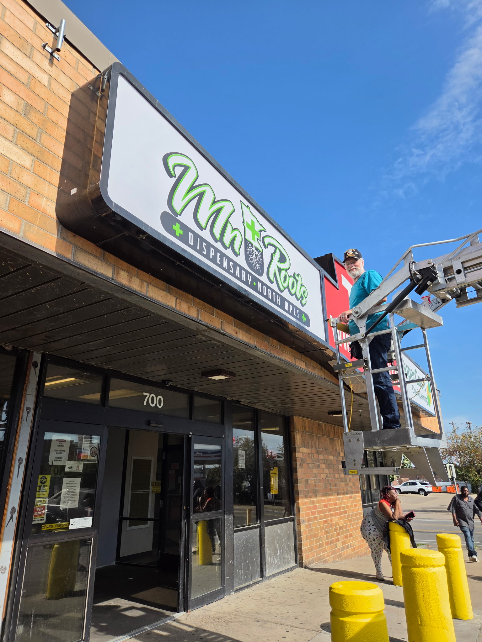 Completed MN Roots dispensary exterior signage at 700 West Broadway in Minneapolis, Minnesota